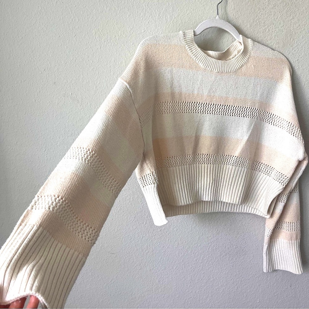 wide, bell-sleeved ivory and nude stripe cable knit crewneck sweater